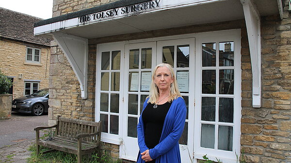 Roz Savage MP stood in front of Sherston Surgery looking disappointed