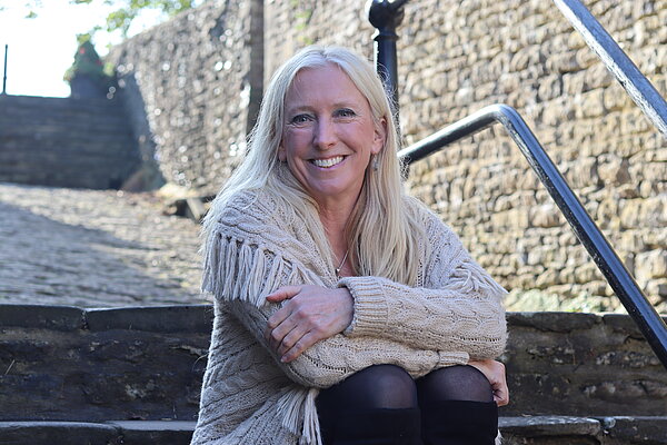 Roz Savage MP sitting on the stairs at The Chippings